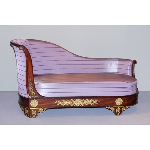 A late empire carved, veneered and gilt mahogany and ormolu mounted meridienne in the manner of Jeanselme